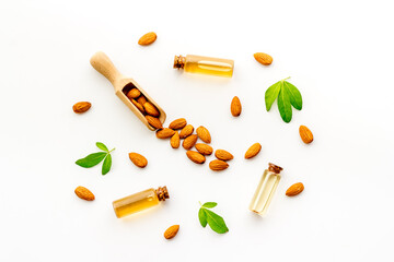 Almond nuts and almond oil in glass jar. Organic food and cosmetic background