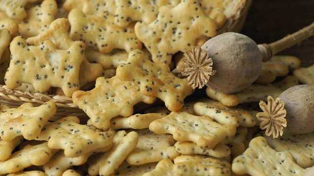 Baked party poppy seed crackers, dry poppy heads . Salty snacks