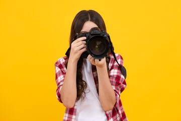Teenager lifestyle, teen hipster hold professional camera. Girl with photo camera photographing,...