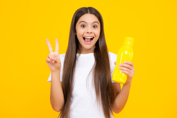 Teen holds water bottle isoalted on yellow. Child girl care body hydration. Active leisure and...