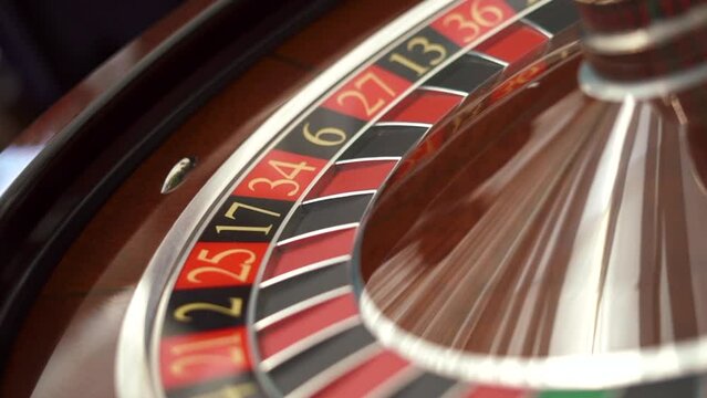 shooting at an angle, The small ball into the slot as the Roulette Wheel spins. High quality FullHD footage