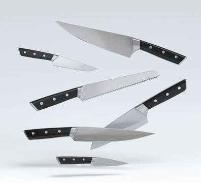 Set of fluing chef's kitchen knives with a wooden handle on white background.