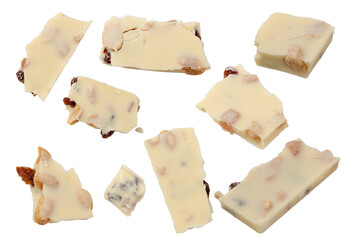 White chocolate. Pieces of white chocolate with nuts, raisins and candied fruit, flying on a white background.