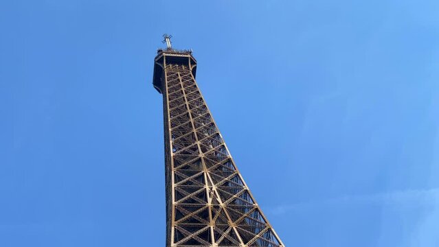 Low angle shot of the Eiffel Tower on a spring day with blue sky in Paris, France