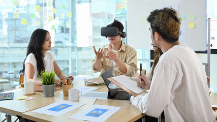 Businessman wearing virtual reality headset at business meeting. Teamwork, startup, innovation...