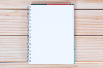 Plain white notepad on a wooden background.