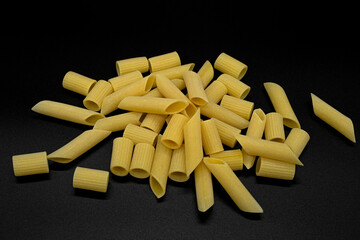 Fresh raw uncooked penne and maccaroni pasta,italian healthy eating kitchen food background 