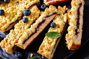 sliced blueberry crumble pie on plate, top view