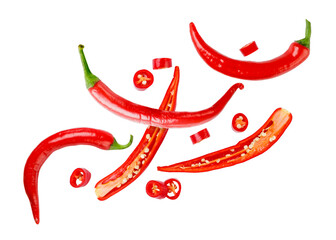 Chili pepper cut into pieces flies on a white. Isolated