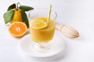 Glass of Citrus Juice on White Wooden Tray Fresh Mandarin Orange on White Background Citrus Drink Horizontal
