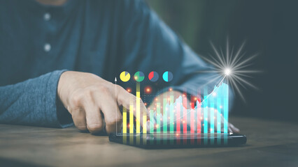 financial and investment technology concept men's hands are active Smartphone to plan stock chart...