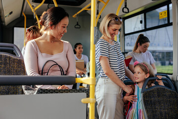 Child with mom talk to passenger on bus © bernardbodo
