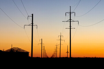 Fototapeta na wymiar electric poles,wires against the sunset sky