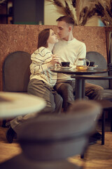 lovers kissing in cafe