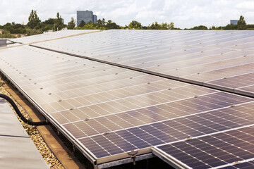 Solar panels Solar System on city background. Solar Photovoltaic cells Solar Station on roof of Apartment Building on Skyscraper Background. Close up. 