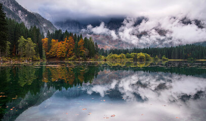 Autumn by lake Fusine in Italy