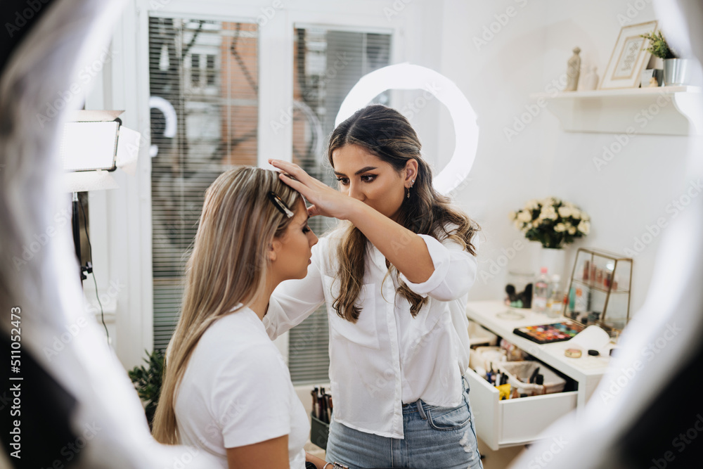 Canvas Prints makeup process. professional artist applying make up on model face. close up portrait of beautiful b