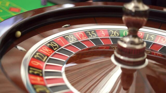 The small ball rolling into the slot as the Roulette Wheel spins. Casino concept. High quality FullHD footage
