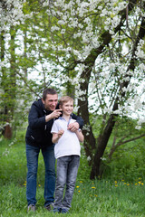 Dad walks with his son and points to the side with his hand