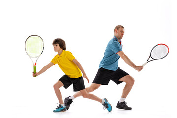 Male tennis player, coach training with teen to play tennis isolated over white studio background. Concept of sport, achievements, hobby, skills - obrazy, fototapety, plakaty