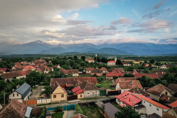 Obraz premium Transylvanian old village of Porumbacu photographed from drone with Fagaras mountains in the background