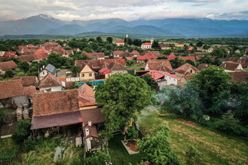 Fototapeta na wymiar Transylvanian old village of Porumbacu photographed from drone with Fagaras mountains in the background