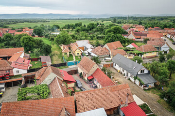 Fototapeta na wymiar Transylvanian old village of Porumbacu photographed from drone with Fagaras mountains in the background