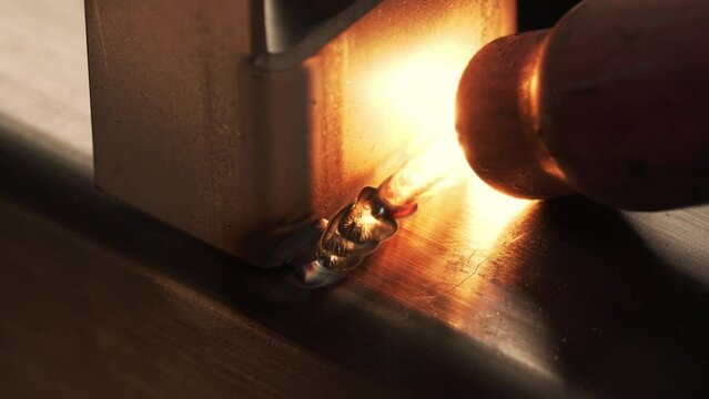 Professional male welder with gas tungsten arc welding (GTAW) or tungsten inert gas (TIG), Closeup shot
