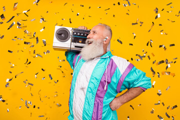 Profile photo of cheerful person carry boombox wear 90s set fabric clothes isolated on yellow color...