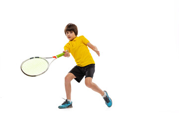 One sportive kid playing tennis isolated over white studio background. Concept of sport,...