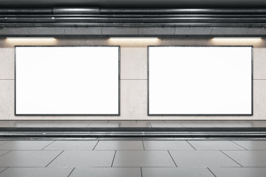 Front view on two blank white billboards in black frame with empty space in undeground area with dark ceiling and grey floor. 3D rendering, mock up
