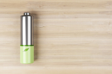 Green energy concept with front view on green leaf printed on silver battery on light wooden background with space for your logo or text. 3D rendering, mock up