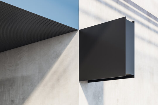 Perspective View On Blank Black Signage With Place For Your Logo Or Advertising On Sunlit Concrete Wall Outdoor. 3D Rendering, Mockup