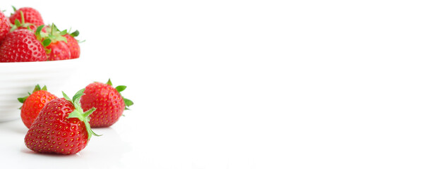 Red ripe strawberry in the white bowl, isolated