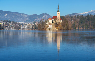 Lake Bled on a cold winter day with frozen ice. Icy water on the lake. 
