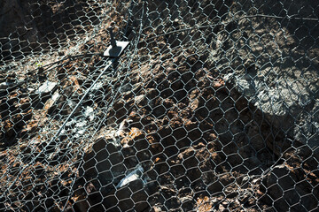 Ground surface with metal protecting net. Metal mesh background.