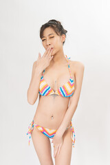 Portrait of a young and attractive sexy asian female lady model wearing colorful summer bikini posing with different gestures and friendly look, very good for holiday concept