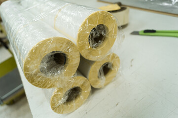 Packing rollers with self-adhesive white label in a transparent stretch film. Preparation of...