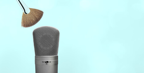 ASMR blue background with studio microphone and makeup brush. 