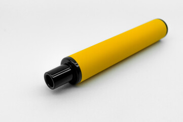 Modern electronic cigarette on a white background. Fashionable smoking device. E-cigarette for vaping. Trendy vape pod. Selective focus