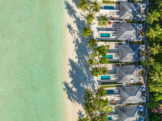 Tropical beach and water bungalows. Travel and tourism to luxury resorts in the Maldives islands....