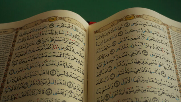 An open page of Quran. Quran is an Islamic Holy Book for all muslims. Selective focus.