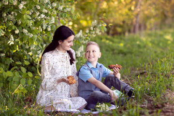 Cute baby treats mom to picnic food