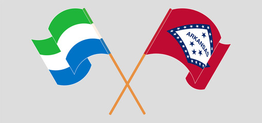 Obraz premium Crossed and waving flags of Sierra Leone and The State of Arkansas