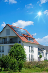 Fototapeta home with solar energy green plants and sunny blue sky obraz