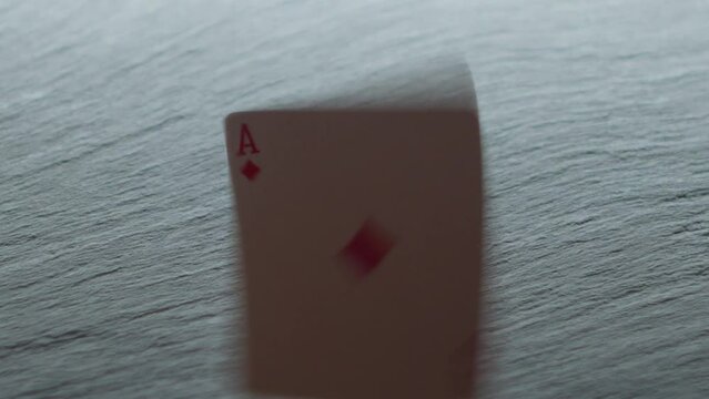 ace of diamonds falling on the table in slow motion
