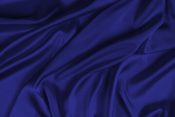 Red silk or satin luxury fabric texture can use as abstract background. Top view.