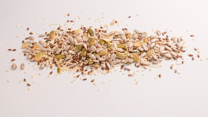 Mix of seeds for a salad. A pile of mixed seeds isolated on white background.