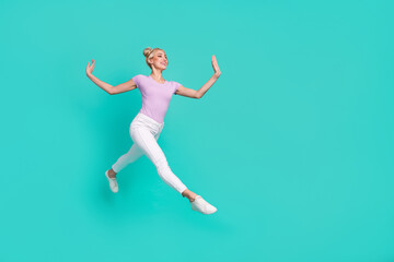Fototapeta na wymiar Full length body size view of attractive cheerful glad sportive girl jumping dancing going isolated over teal turquoise color background
