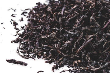 dried black tea on a white acrylic background
